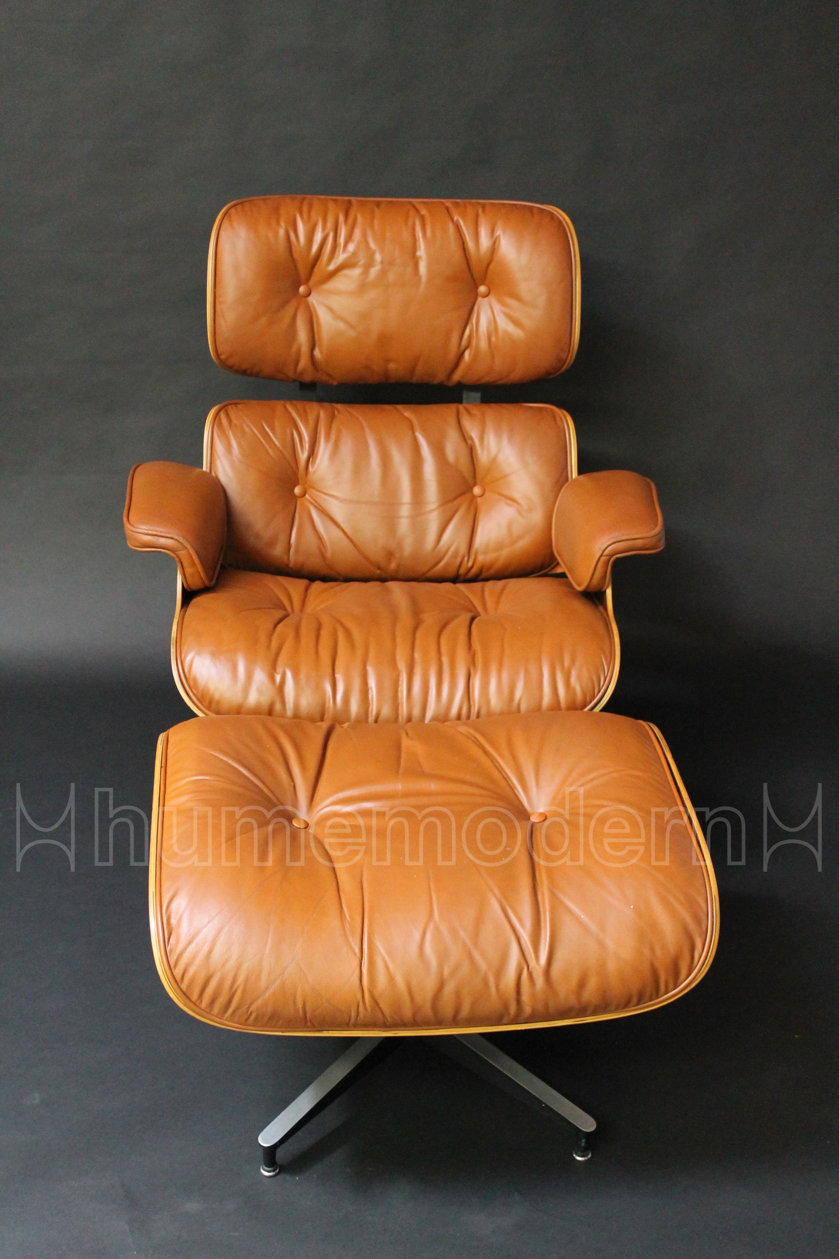 front view of brown leather eames lounge and ottoman photo