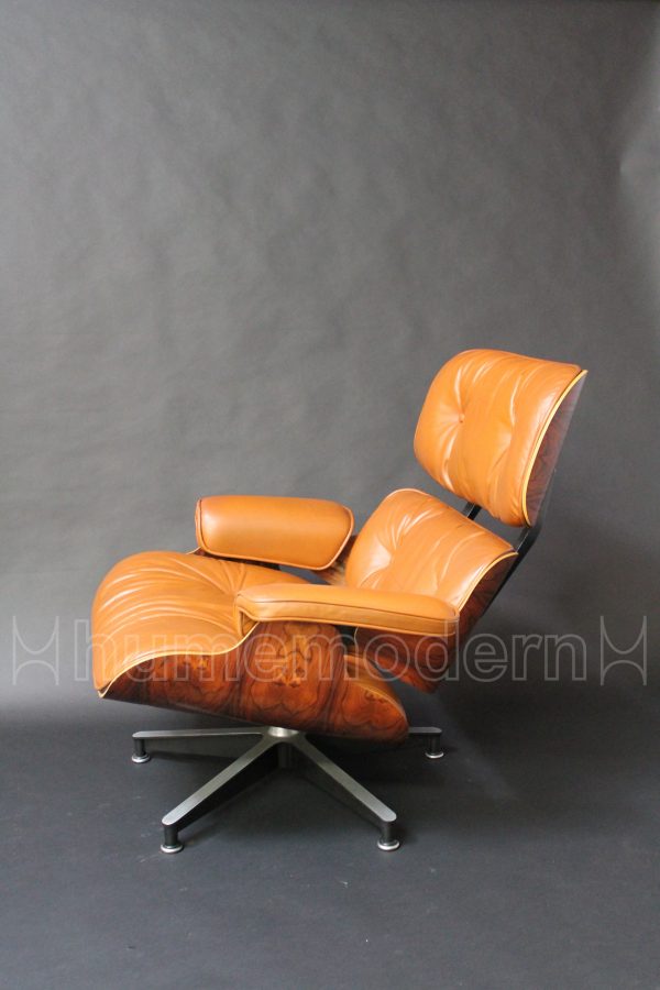 side view of brown leather eames lounge and ottoman photo