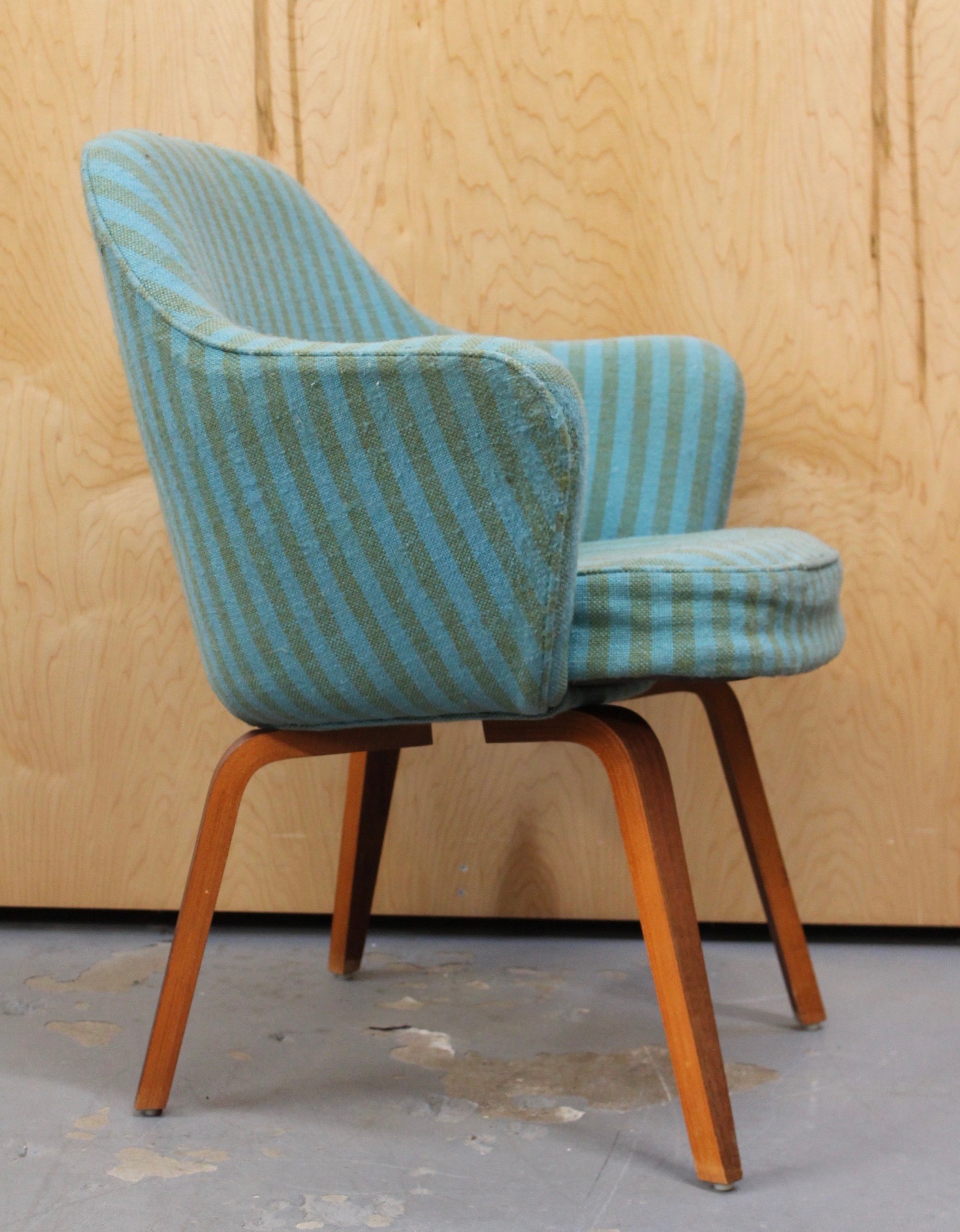 vintage saarinen arm chair with blue striped fabric and wood legs