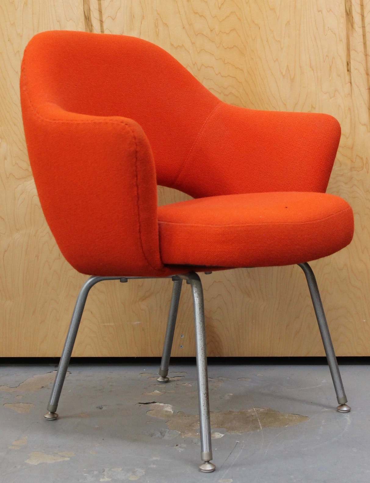 photo of side of vintage orange fabric chair with metal legs