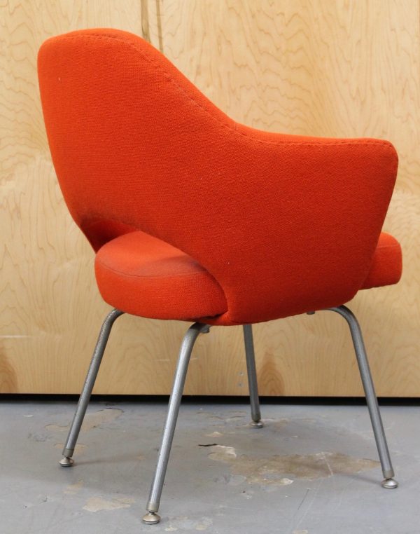 photo of side of vintage orange fabric chair with metal legs