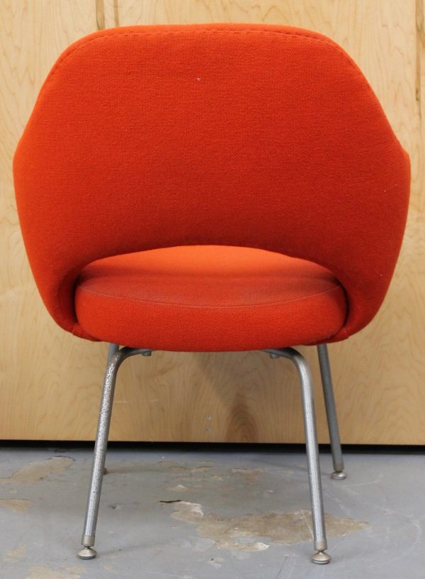 photo of back of vintage orange fabric chair with metal legs