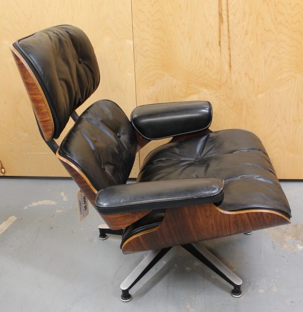 photo of side of rare Eames black leather and dark wood lounge chair