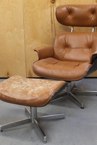photo of front of distressed brown leather Plycraft lounge chair and ottoman