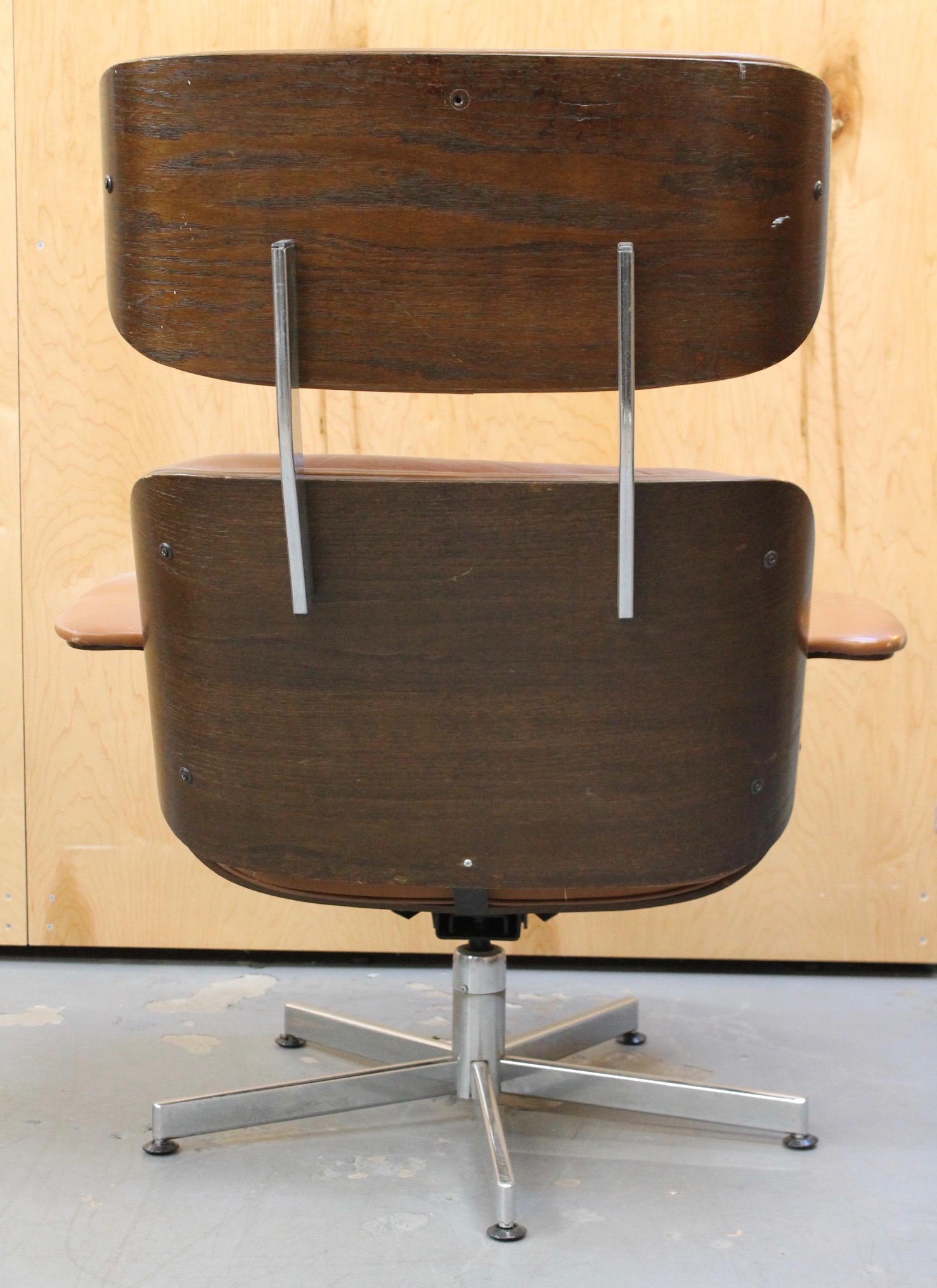 photo of back of distressed brown leather lounge chair and ottoman