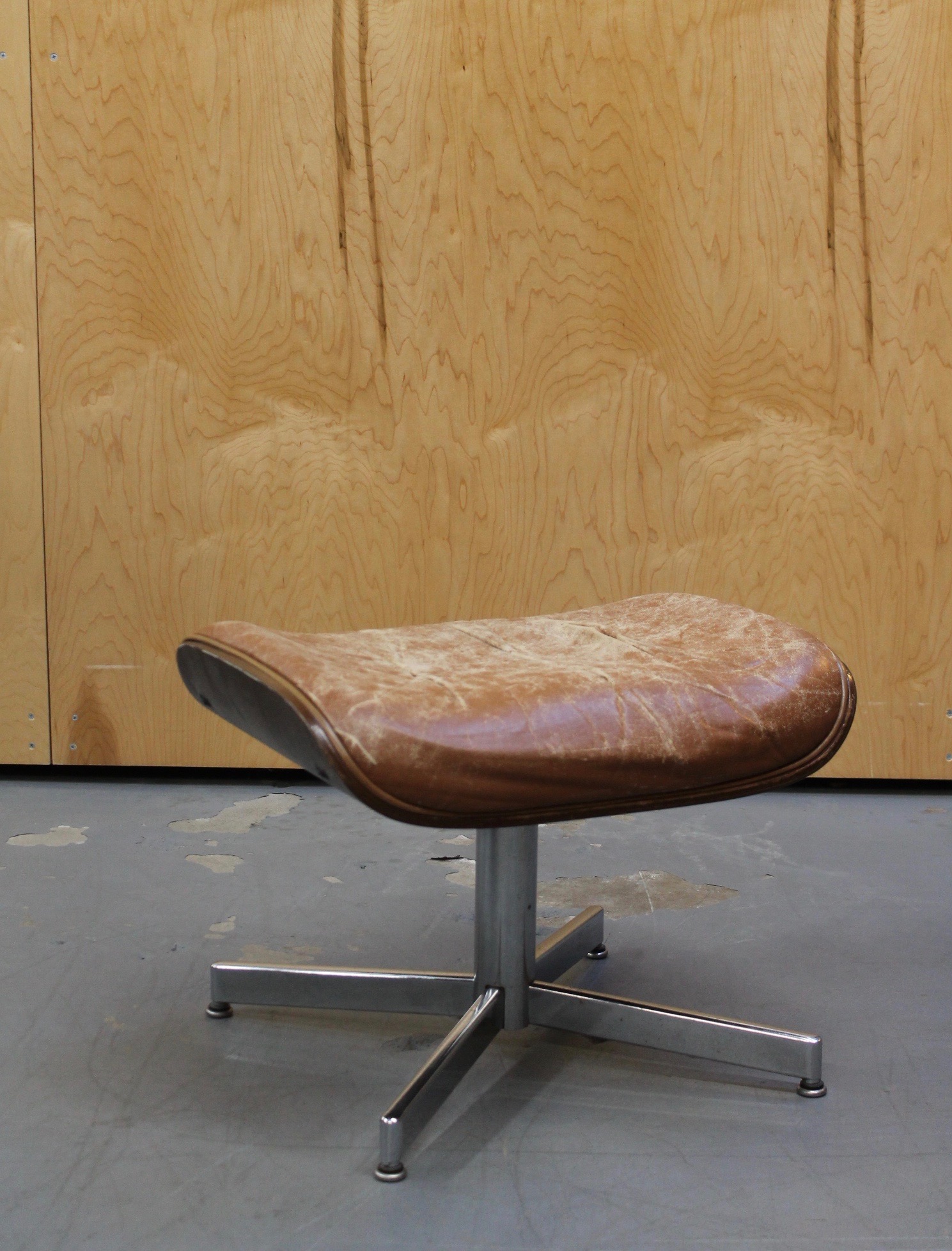 photo of front of distressed brown leather ottoman