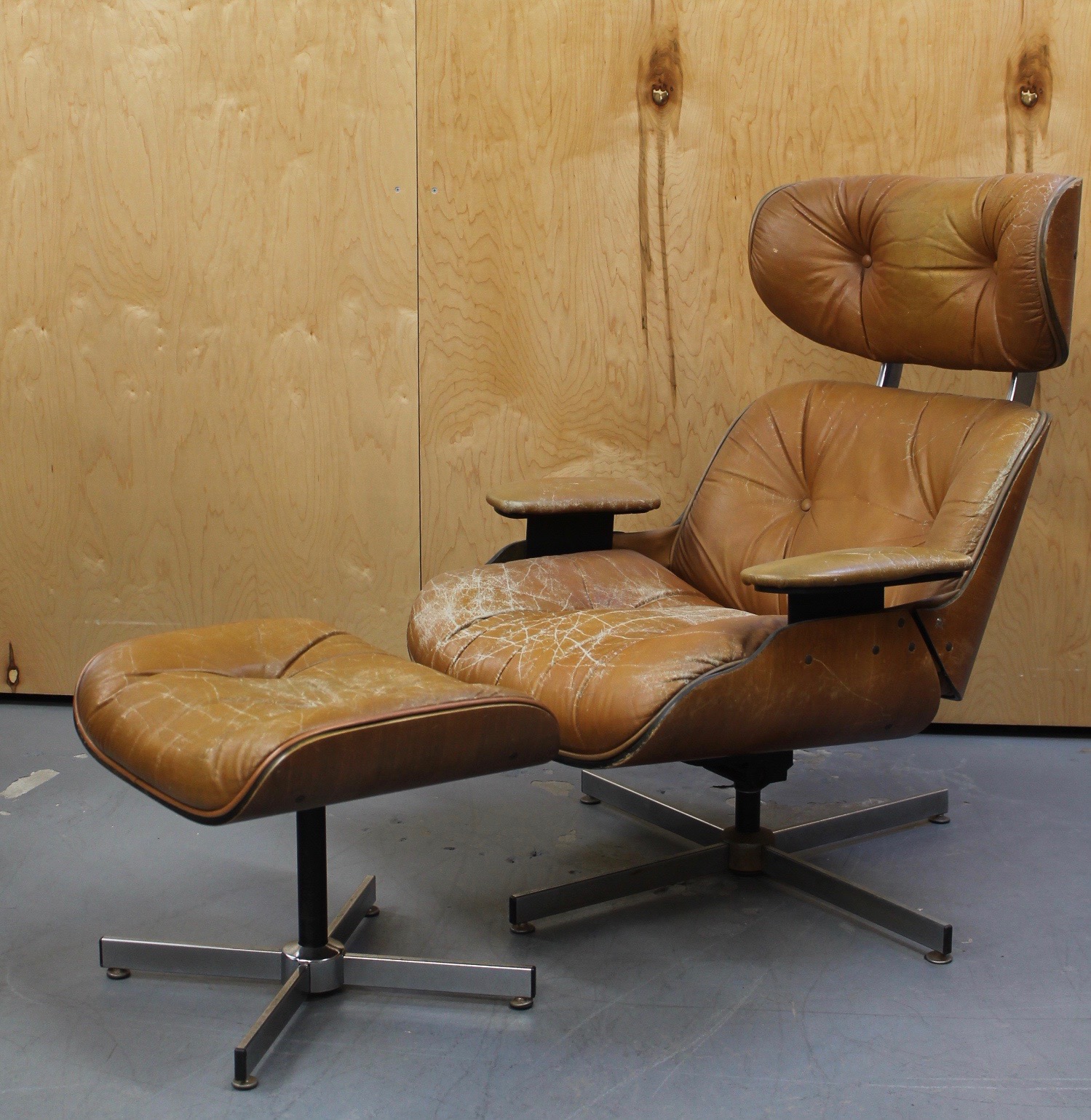 Plycraft Lounge and Ottoman photo of side of distressed brown leather lounge chair and ottoman