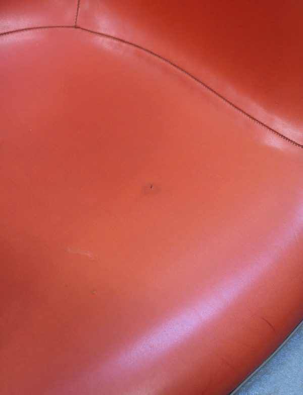 photo of closeup of eames red arm chair shell fabric