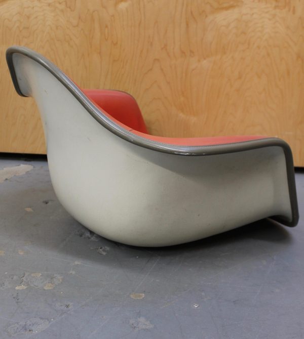 photo of back angle of eames red arm chair shell