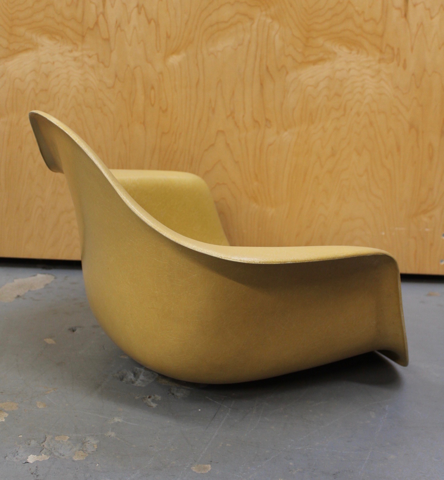photo of eames mustard colored arm chair shell