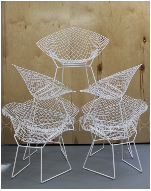 stack of white powder coated Knoll Bertoia metal basket chairs