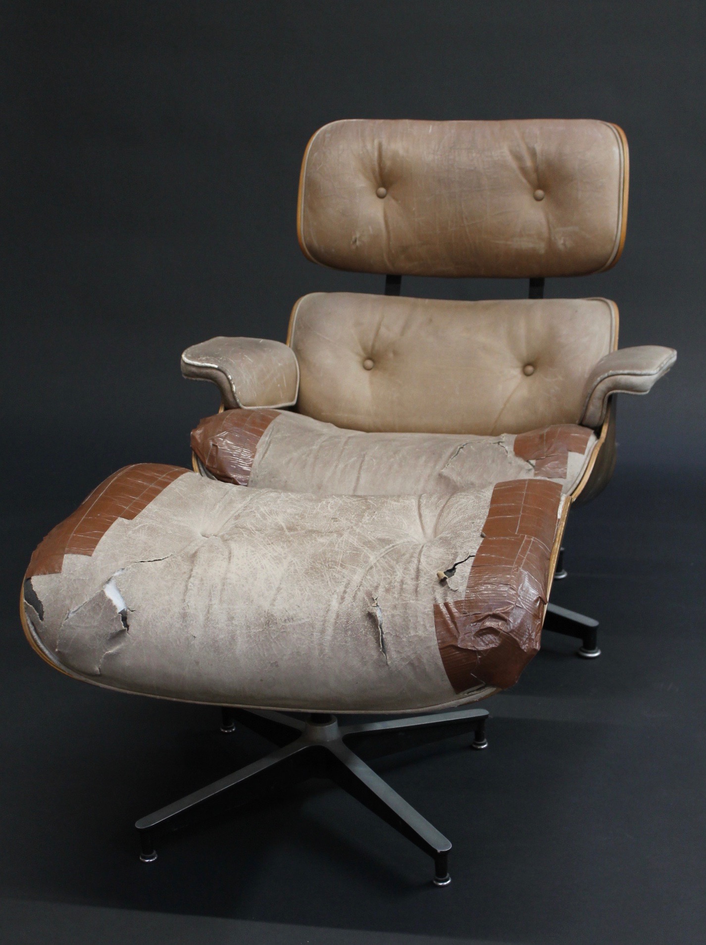 repair restoration eames project lounge chair distressed and torn leather eames lounge chair and ottoman front view photo