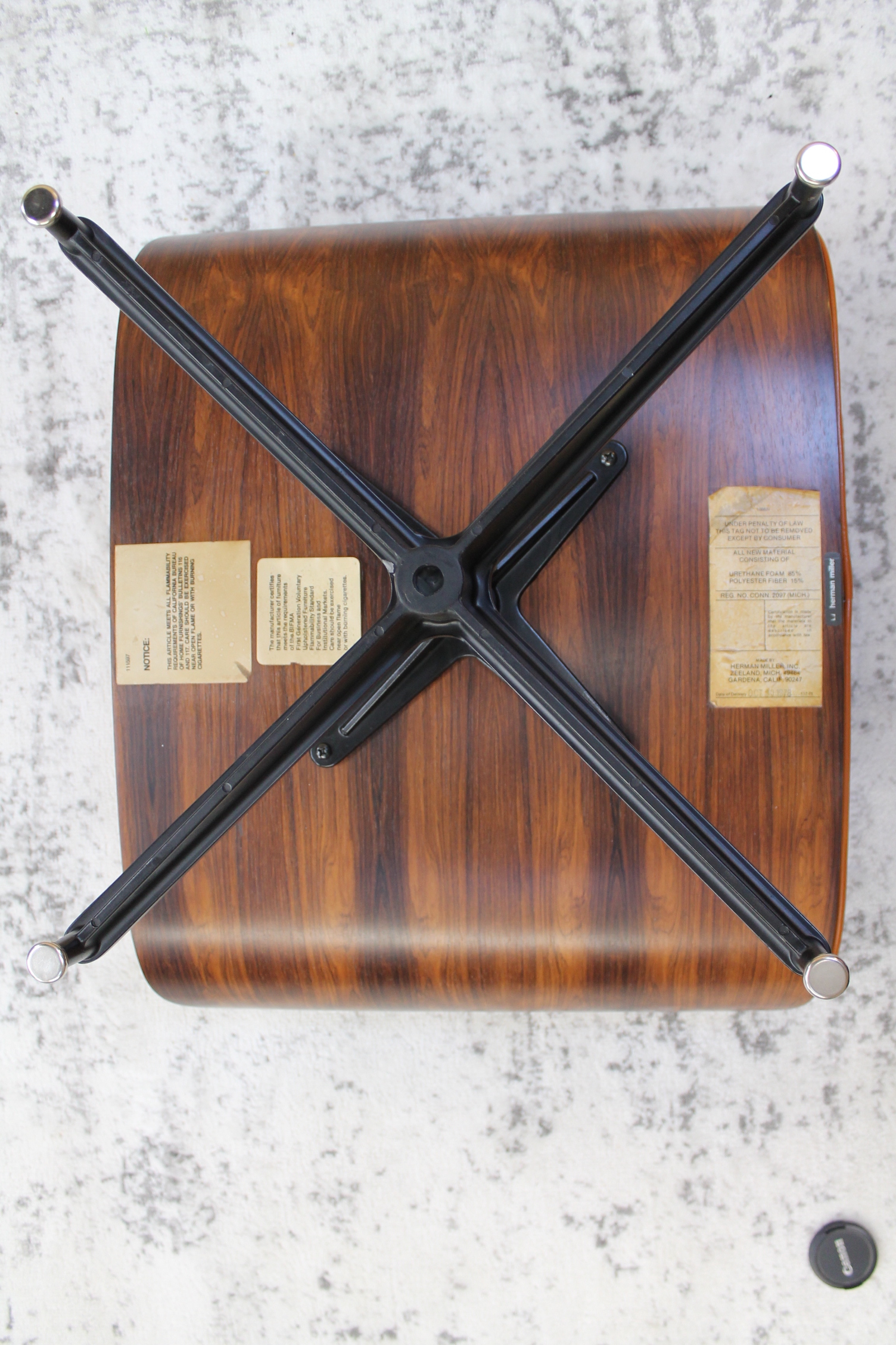 underside of wood and leather ottoman metal legs